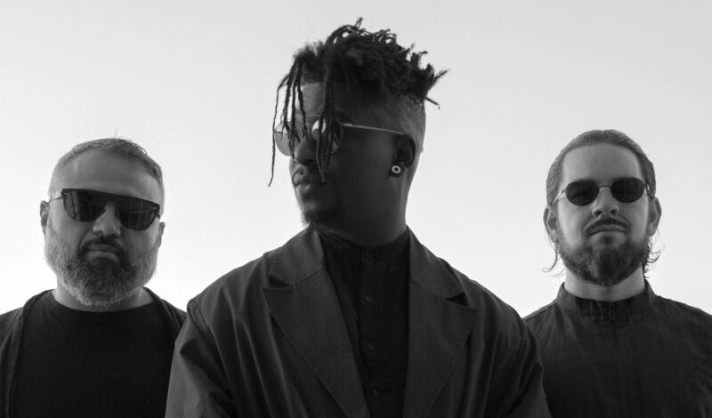 Die drei Musiker des Progressive-Metal-Band Animals as Leaders als Silhouette zu sehen.